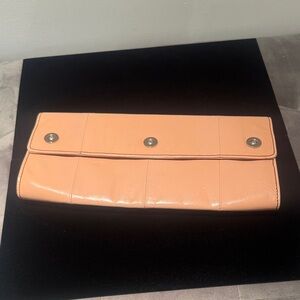 Kenneth Cole Peach/petal pink Clutch.
Vintage now. Excellent condition.